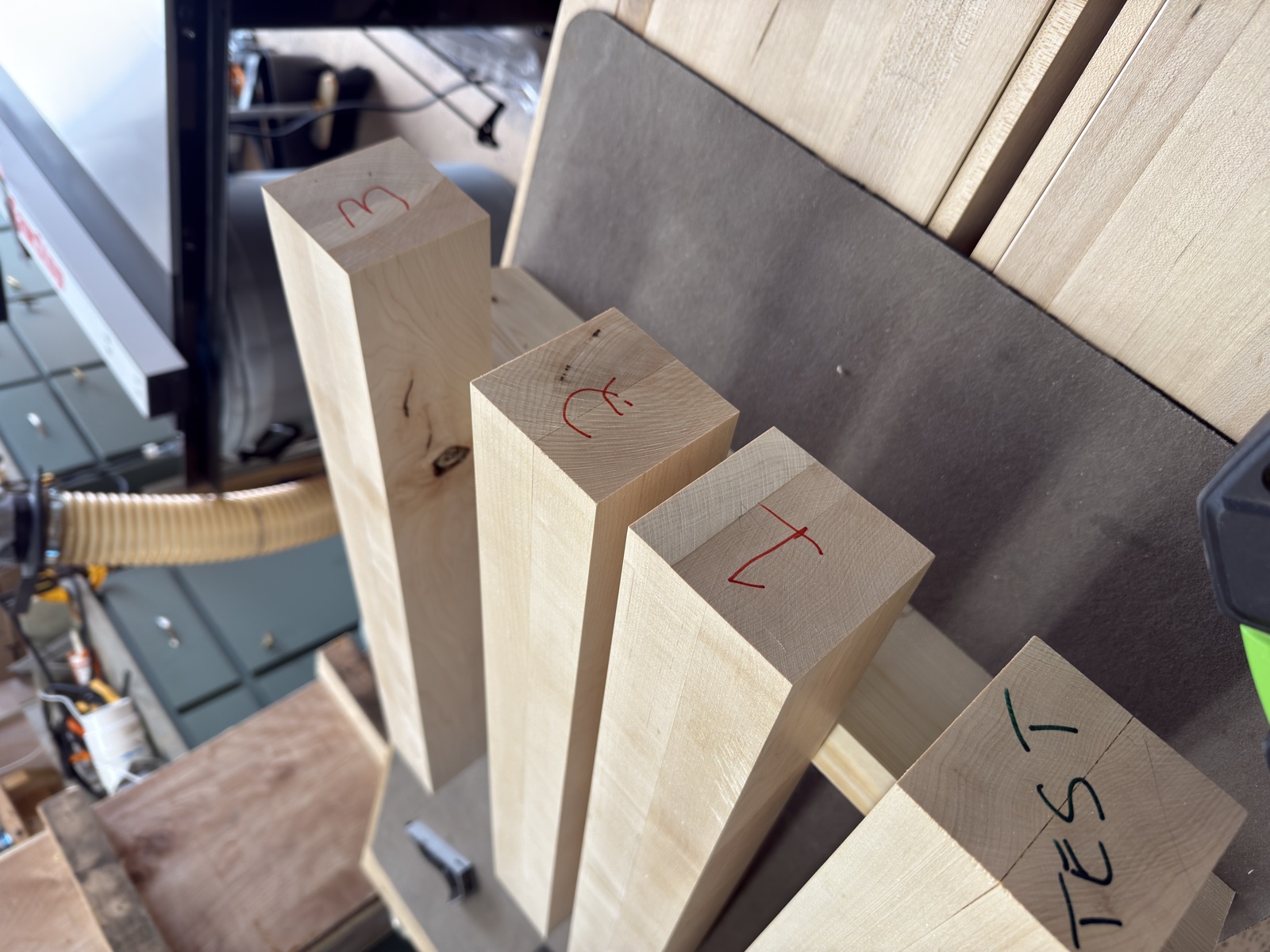 Dimensioned maple leg blanks marked for joinery